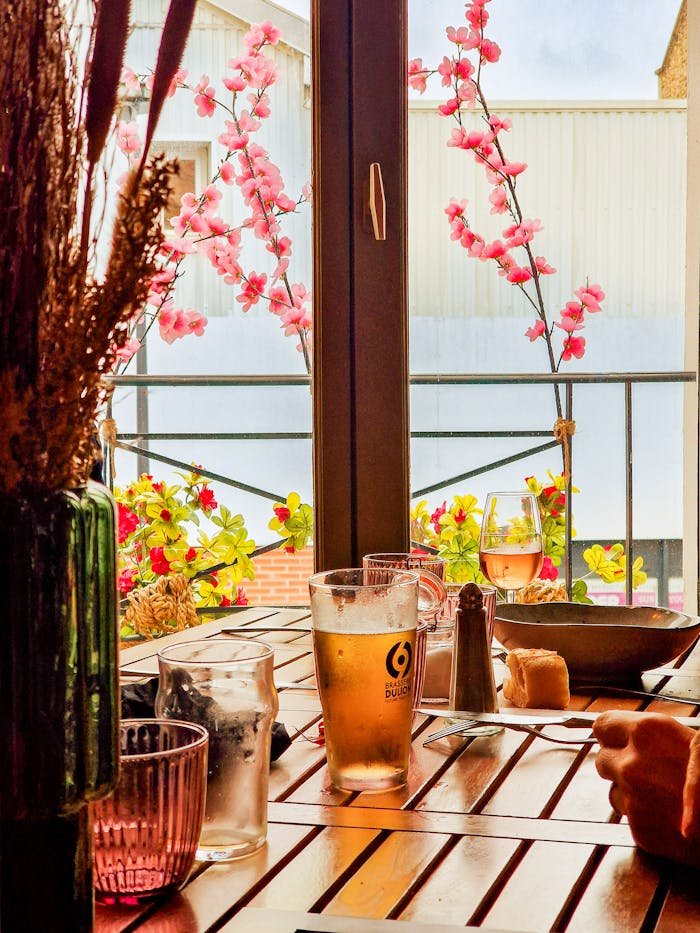 Warm and inviting dining scene with drinks and flowers in Montreuil, IDF, France.
