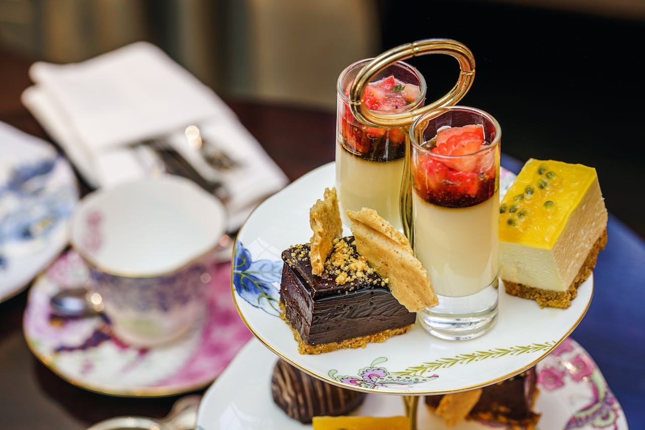 Indulge in a selection of gourmet desserts at an elegant high tea setup in London.